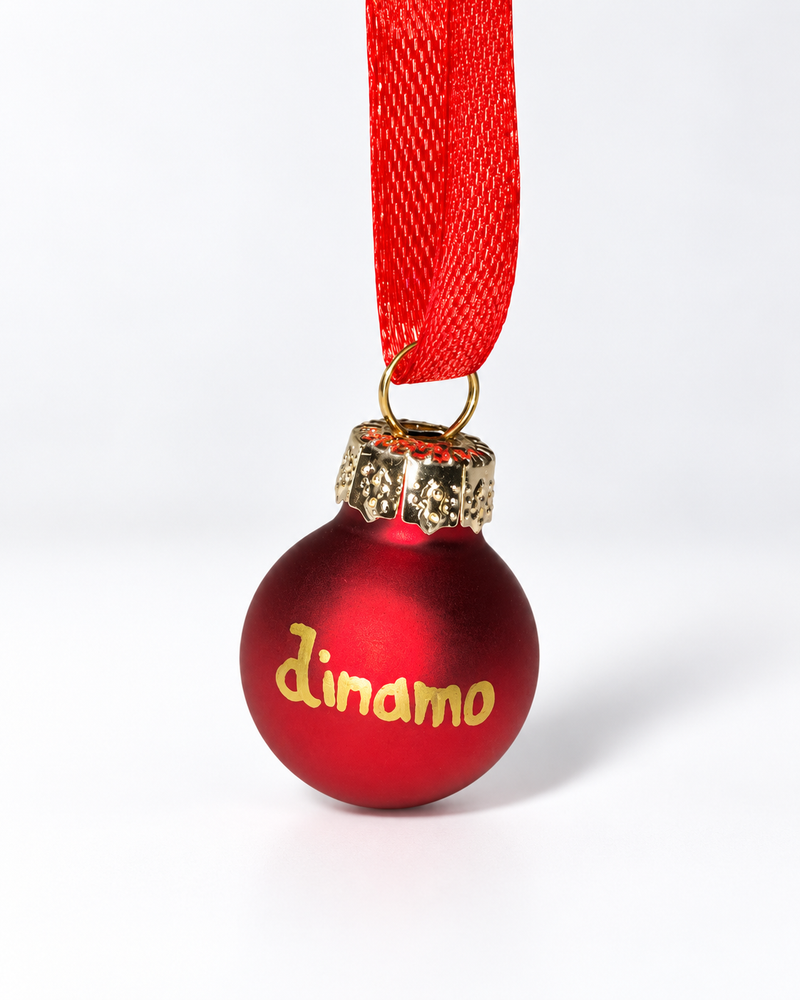 Tiny handmade matte red glass Christmas ornament with gold Dinamo lettering and red ribbon hanger