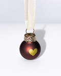 Tiny handmade dark brown glass Christmas ornament with gold heart design and white ribbon hanger