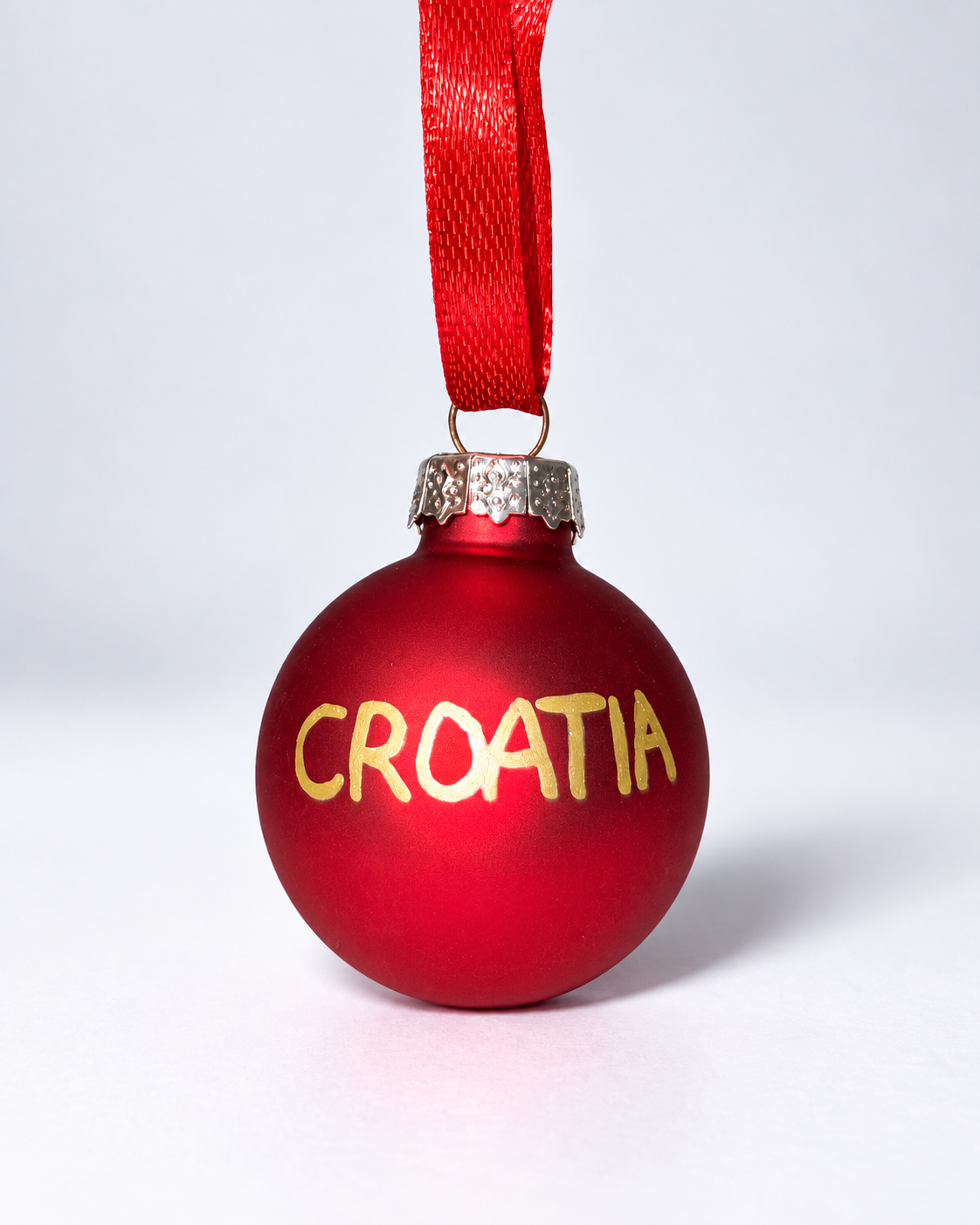 Handmade red glass Christmas ornament with gold CROATIA lettering and red ribbon hanger